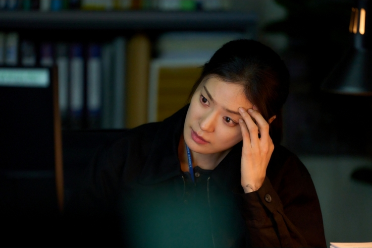 Lee Hwa-young examining investigation material